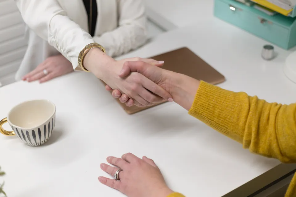 Business handshake across a table